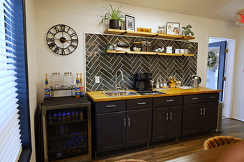 A kitchen with beverages and wooden countertops.